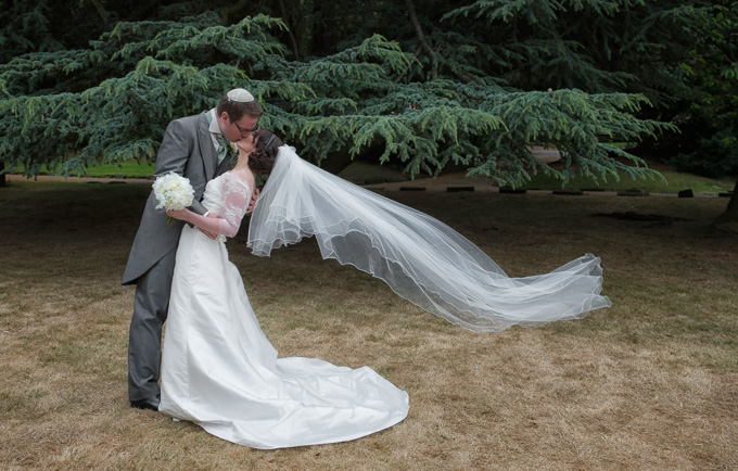 Wedding photograph of couple kissing in the garden