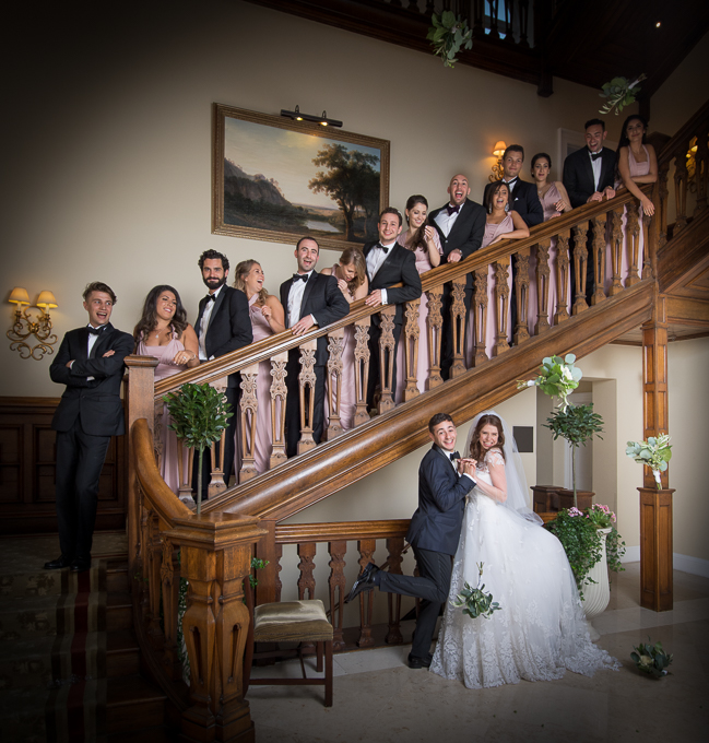 Wedding photography - guests leaning on banister on staircase