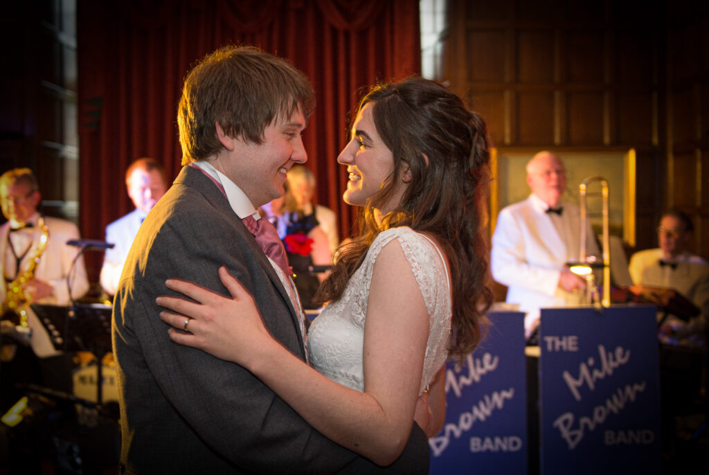 Bride and groom's first dance with a live band performing at a Goldsborough Hall wedding reception.