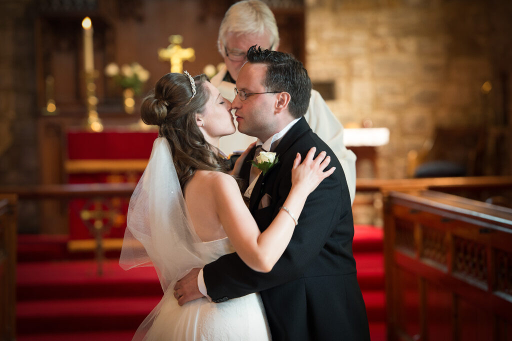 The first kiss at the altar during a York church wedding ceremony.