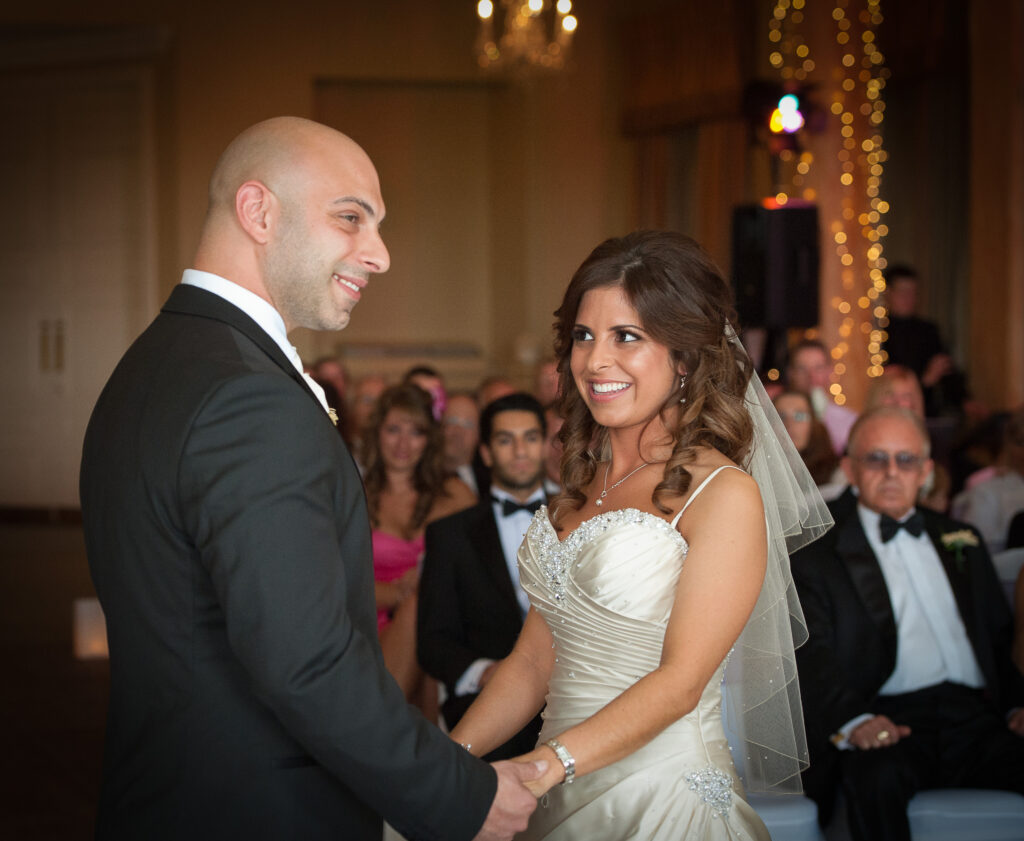 Close-up of a bride and groom exchanging vows during a ceremony at Rudding Park.