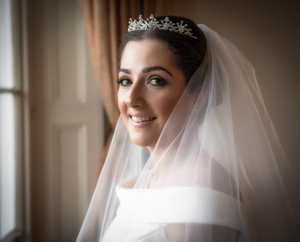Professional bridal portrait at Oulton Hall, Leeds, showcasing elegant wedding dress details and natural lighting.