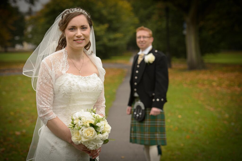 Bride holding a white rose bouquet in North Yorkshire.