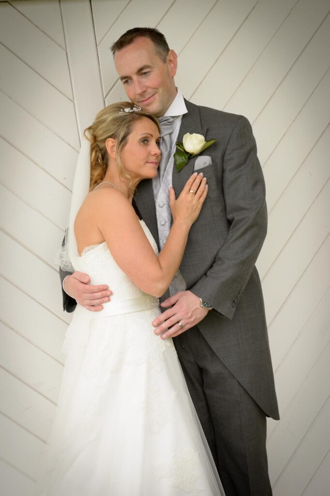 Close-up portrait of a bride leaning against the groom's chest, captured by Howard Barnett Wedding Photographer in Leeds, West Yorkshire