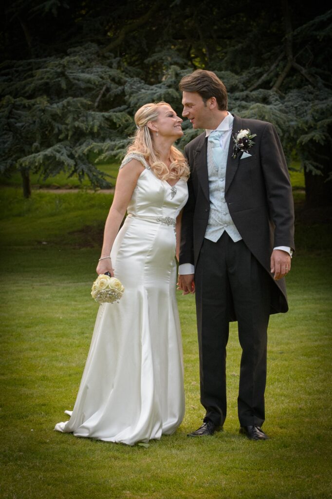 Full Length Portrait: "The bride and groom sharing a look of love on the grounds of a wedding venue near Leeds."