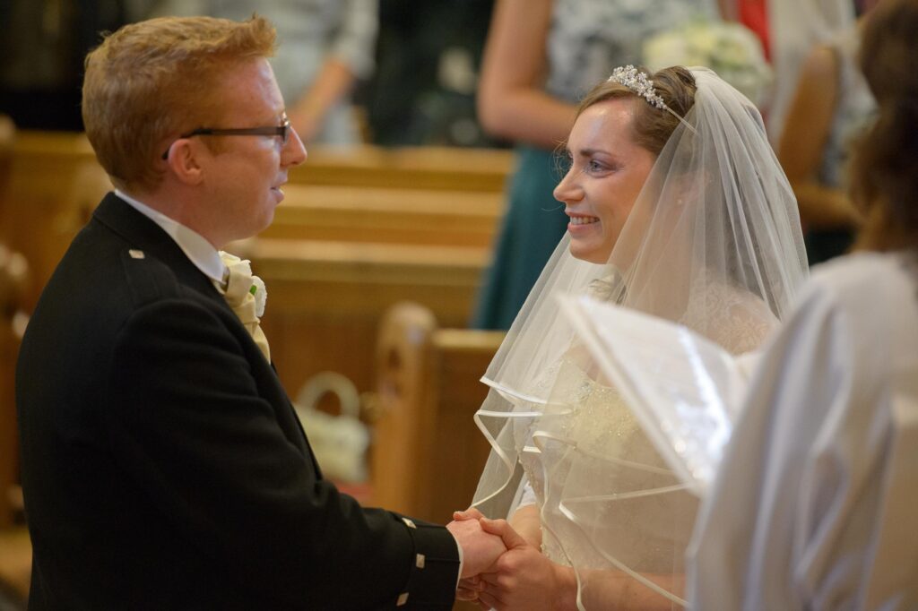 Close-up of bride and groom during vows at Christ Church.