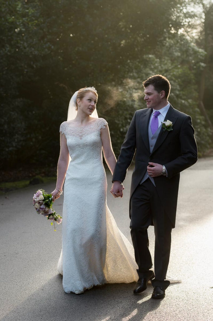 Candid wedding photography of Ally and Harry in the gardens at Weetwood Hall Leeds by wedding photographer Howard Barnett.