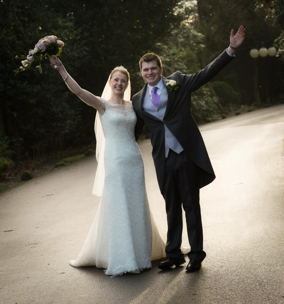 Candid wedding photography of Ally and Harry in the gardens at Weetwood Hall Leeds by wedding photographer Howard Barnett.